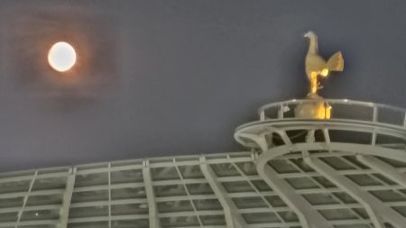 The full moon rises over the South Stand
